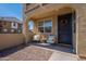 Inviting front porch showcasing seating area and wreath on the front door of this lovely townhome at 1255 N Arizona Ave # 1246, Chandler, AZ 85225