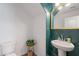 Stylish half bathroom with a pedestal sink and decorative green wallpaper accent at 1255 N Arizona Ave # 1246, Chandler, AZ 85225