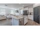 Open-concept kitchen with granite island, stainless appliances, flows into a cozy living area at 1255 N Arizona Ave # 1246, Chandler, AZ 85225