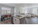 Open-concept kitchen with central island, stainless steel appliances, and views into the living area at 1255 N Arizona Ave # 1246, Chandler, AZ 85225