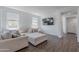 Bright living room featuring a comfortable beige sofa and wood-look tile flooring at 1255 N Arizona Ave # 1246, Chandler, AZ 85225