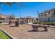 Community playground featuring a climbing structure, a seating area, and a log at 1255 N Arizona Ave # 1246, Chandler, AZ 85225
