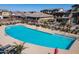 Community pool surrounded by lounge chairs and landscaped grounds, perfect for relaxation at 1255 N Arizona Ave # 1246, Chandler, AZ 85225