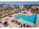View of the community pool with lounge seating and mature landscaping at 1255 N Arizona Ave # 1246, Chandler, AZ 85225