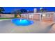 An illuminated backyard pool at night with an inviting glow and patio at 13014 N 23Rd Pl, Phoenix, AZ 85022