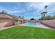 Backyard showcasing a refreshing swimming pool and covered patio area, perfect for outdoor living at 13014 N 23Rd Pl, Phoenix, AZ 85022