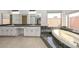 Bathroom with dual sinks, vanity area, and a luxurious soaking tub by the window at 13014 N 23Rd Pl, Phoenix, AZ 85022