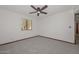 Bright bedroom with a ceiling fan and window, showcasing neutral walls and flooring at 13014 N 23Rd Pl, Phoenix, AZ 85022