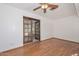 The bedroom features hardwood floors, a ceiling fan, and glass french doors at 13014 N 23Rd Pl, Phoenix, AZ 85022