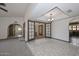 Elegant dining room with a decorative ceiling, stylish chandelier, and easy access to multiple rooms in the home at 13014 N 23Rd Pl, Phoenix, AZ 85022
