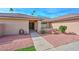 Charming single-story brick home with a red rock garden and covered front entrance at 13014 N 23Rd Pl, Phoenix, AZ 85022