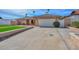 Well-kept home with a brick exterior, mature landscaping, and a wide driveway leading to the garage at 13014 N 23Rd Pl, Phoenix, AZ 85022