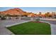 The front yard has a healthy green lawn with the desert mountain in the background at 13014 N 23Rd Pl, Phoenix, AZ 85022