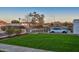 The front yard has a healthy green lawn and landscaping with views of the desert mountains at 13014 N 23Rd Pl, Phoenix, AZ 85022