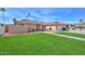 Beautiful single-story home with well-maintained landscaping, a brick facade, and a tile roof at 13014 N 23Rd Pl, Phoenix, AZ 85022