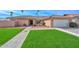 Charming single-story home featuring a well-manicured lawn and a two-car garage at 13014 N 23Rd Pl, Phoenix, AZ 85022
