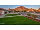 Neighborhood view showcasing the lush front yard with mountain views at 13014 N 23Rd Pl, Phoenix, AZ 85022