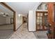 Hallway view towards a living room with a fireplace, arched doorways and tiled flooring at 13014 N 23Rd Pl, Phoenix, AZ 85022