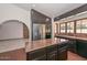 Traditional kitchen features tile flooring, dark wood cabinets, marble countertops, and stainless refrigerator at 13014 N 23Rd Pl, Phoenix, AZ 85022