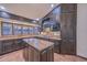 Elegant kitchen with dark cabinets, granite countertops, and a view of the living area at 13014 N 23Rd Pl, Phoenix, AZ 85022