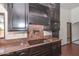 Traditional kitchen features marble countertops, dark wood cabinets, cooktop, and microwave at 13014 N 23Rd Pl, Phoenix, AZ 85022