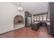 Well-equipped kitchen featuring modern appliances, granite countertops, and abundant natural light, open to brick fireplace lounge at 13014 N 23Rd Pl, Phoenix, AZ 85022