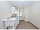 Bright laundry room features tile flooring, utility sink, and a window at 13014 N 23Rd Pl, Phoenix, AZ 85022