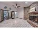 Bright living room with a unique brick fireplace and doors leading to the patio at 13014 N 23Rd Pl, Phoenix, AZ 85022