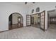 Spacious living room showcasing arched doorways and a decorative doorway with a view to the patio at 13014 N 23Rd Pl, Phoenix, AZ 85022