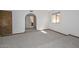 Large carpeted room with arched entryway and a window with a view at 13014 N 23Rd Pl, Phoenix, AZ 85022