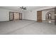 Spacious living room with new carpet, doors to another room, and entry to the kitchen at 13014 N 23Rd Pl, Phoenix, AZ 85022