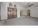 Open living room with high ceiling, carpet flooring, ceiling fan, and french doors at 13014 N 23Rd Pl, Phoenix, AZ 85022