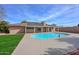 Wide angle view of backyard pool, patio, and well-maintained lawn, ideal for enjoying the outdoors in privacy at 13014 N 23Rd Pl, Phoenix, AZ 85022