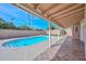 Covered patio overlooking a sparkling pool and lush green lawn, perfect for enjoying outdoor living and entertaining at 13014 N 23Rd Pl, Phoenix, AZ 85022