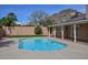 Beautiful pool with refreshing water, surrounded by green grass and privacy walls, nestled against a mountain backdrop at 13014 N 23Rd Pl, Phoenix, AZ 85022