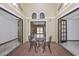 Charming tiled sitting area with ornamental wall lights and decorative windows, featuring wrought iron chairs and table at 13014 N 23Rd Pl, Phoenix, AZ 85022