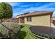 Expansive backyard with vibrant artificial turf and covered patio at 13225 W Rowel Rd, Peoria, AZ 85383