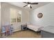 This is a cute bedroom with a grey color scheme and shiplap accent wall at 13225 W Rowel Rd, Peoria, AZ 85383