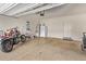 Spacious garage with overhead door, storage and room for vehicles at 13225 W Rowel Rd, Peoria, AZ 85383