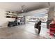Well-organized garage with storage shelves, vehicle, and open door at 13225 W Rowel Rd, Peoria, AZ 85383