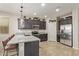 Well-equipped kitchen with stainless steel appliances, a granite island, and modern lighting at 13225 W Rowel Rd, Peoria, AZ 85383