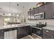 Stylish kitchen featuring granite countertops, stainless steel appliances, and lots of storage at 13225 W Rowel Rd, Peoria, AZ 85383