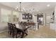 Open kitchen featuring an island, pendant lighting, stainless steel appliances, and a dining area at 13225 W Rowel Rd, Peoria, AZ 85383