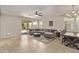 Spacious living room featuring tile floors, neutral colors, and a sliding glass door to the patio at 13225 W Rowel Rd, Peoria, AZ 85383