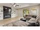 Bright and airy living room with tile floors, built-in shelves, and a fireplace at 13225 W Rowel Rd, Peoria, AZ 85383
