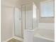 The shower is glass enclosed and features an adjacent soaking tub and a large window at 13225 W Rowel Rd, Peoria, AZ 85383