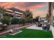 Lovely backyard with faux grass, covered patio, and outdoor kitchen at 1407 E Artemis Trl, San Tan Valley, AZ 85140