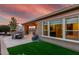 Stunning backyard with patio, outdoor kitchen, and well-manicured synthetic lawn at 1407 E Artemis Trl, San Tan Valley, AZ 85140