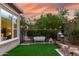 Cozy backyard with faux grass, bench, and ambient string lights at 1407 E Artemis Trl, San Tan Valley, AZ 85140