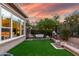 Relaxing backyard space with artificial grass, landscaping, and decorative lighting at 1407 E Artemis Trl, San Tan Valley, AZ 85140